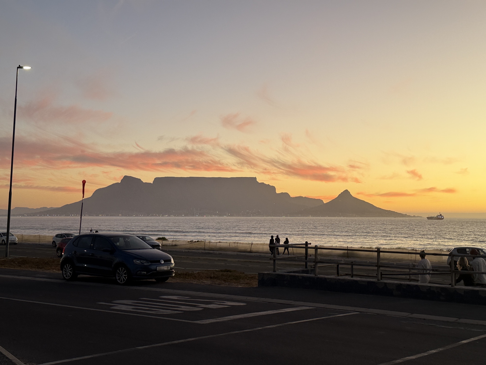 Table Mountain silhouette at golden sunset viewed from Blouberg Beach, Cape Town — kite expedition evening