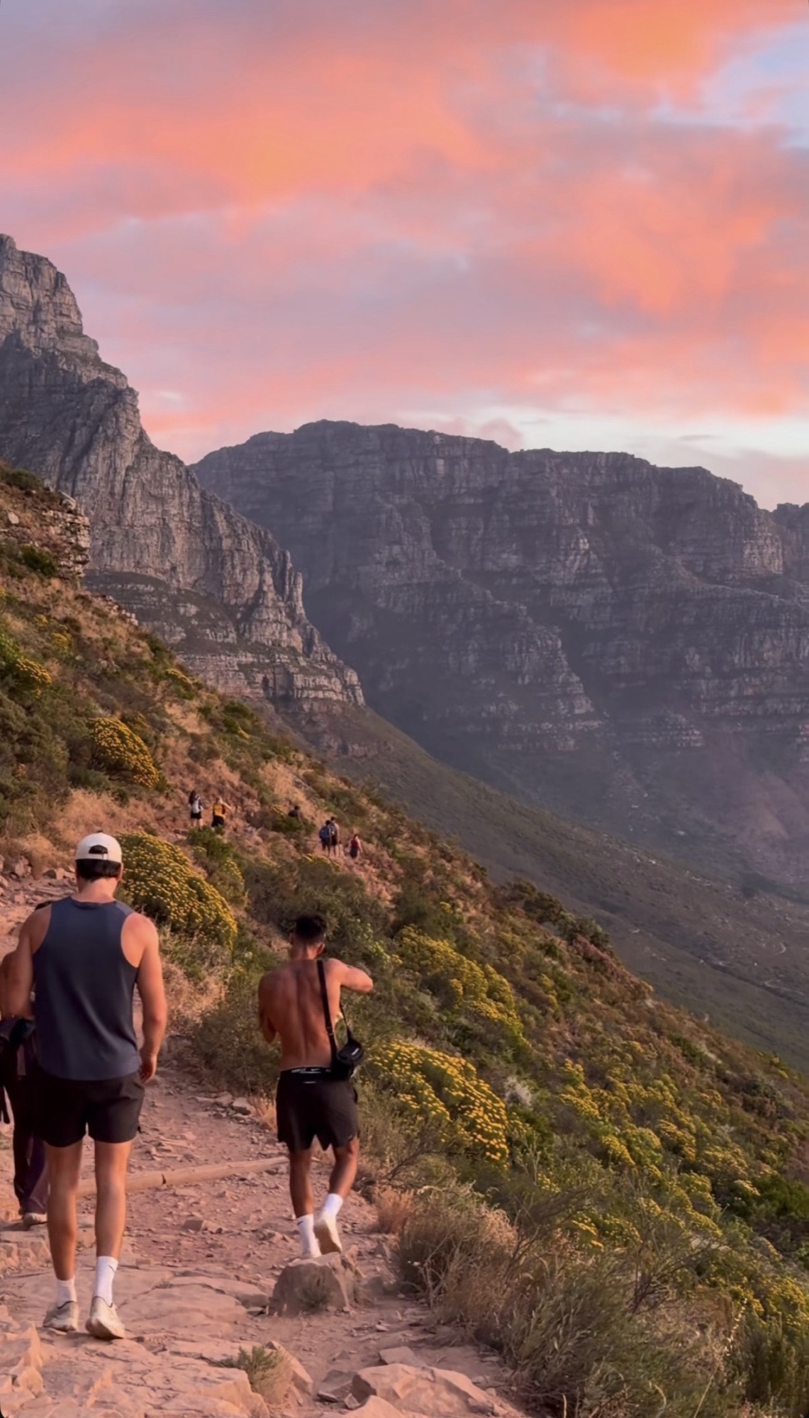 Expedition riders hiking Table Mountain trail at pink sunset, Cape Town — Local Secrets XP off-water activities