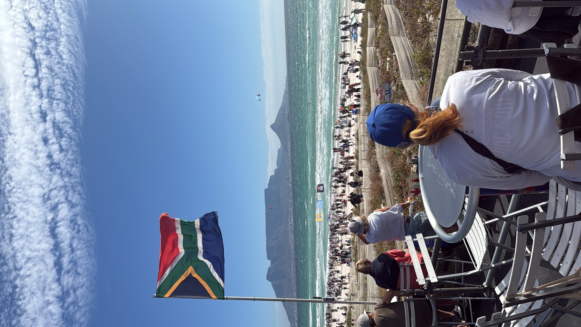 South Africa flag flying at Blouberg Beach with kites and Table Mountain visible — Cape Town expedition