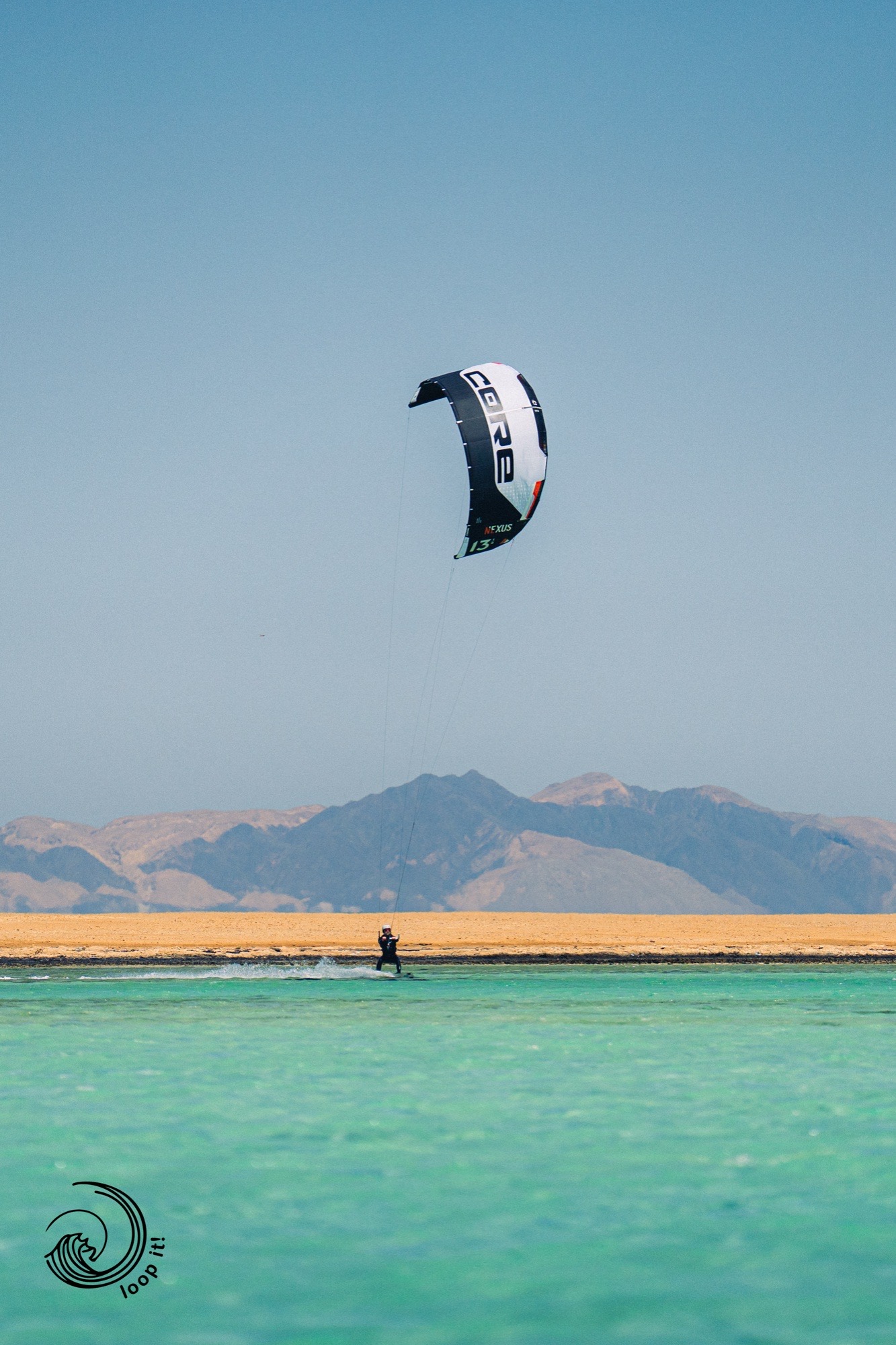 Kitesurfer riding turquoise Red Sea lagoon with Sinai mountains backdrop — Egypt kite expedition Local Secrets XP