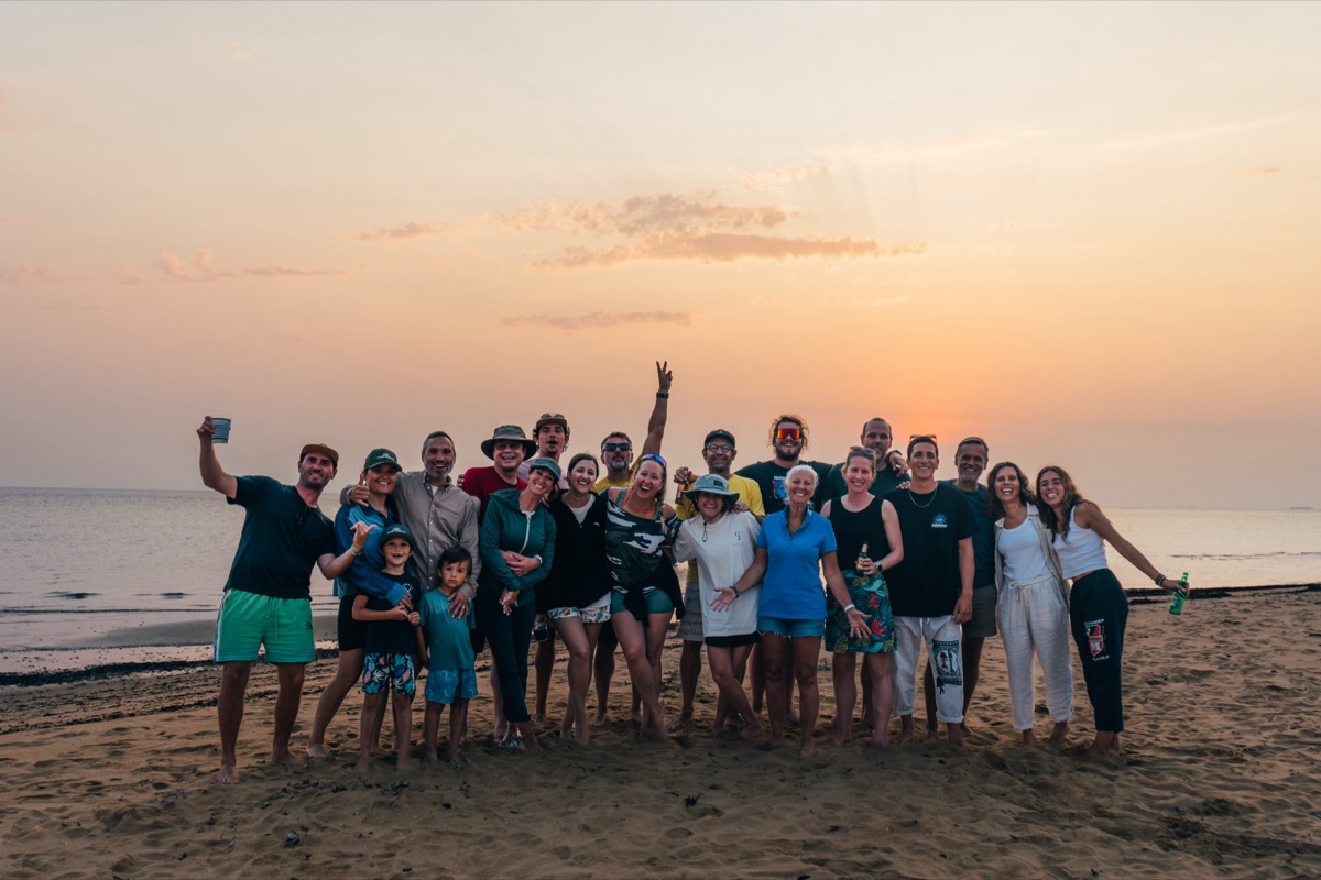 Local Secrets XP expedition group photo on Inhaca Island beach at golden sunset, Mozambique