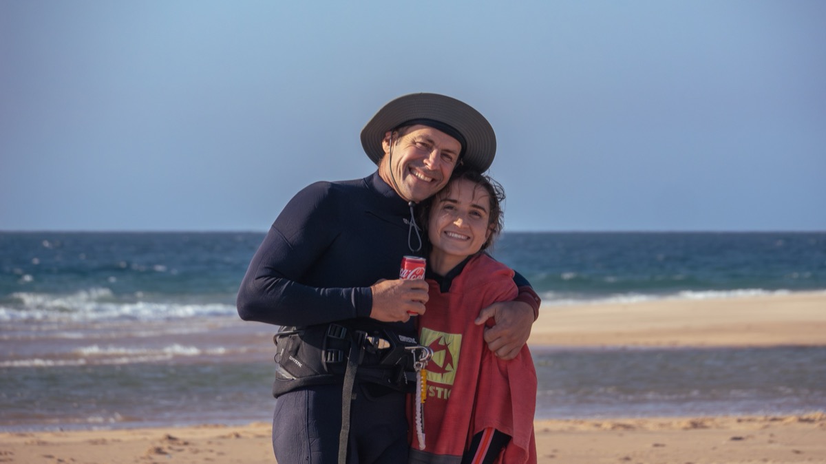 Two kitesurfers smiling on Inhaca Island beach after a session — Local Secrets XP Mozambique